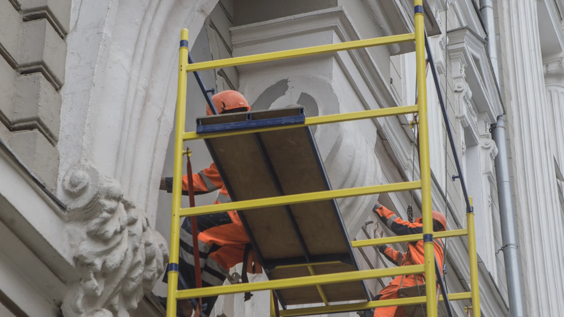 Construction crew restoring historic building while preserving original features